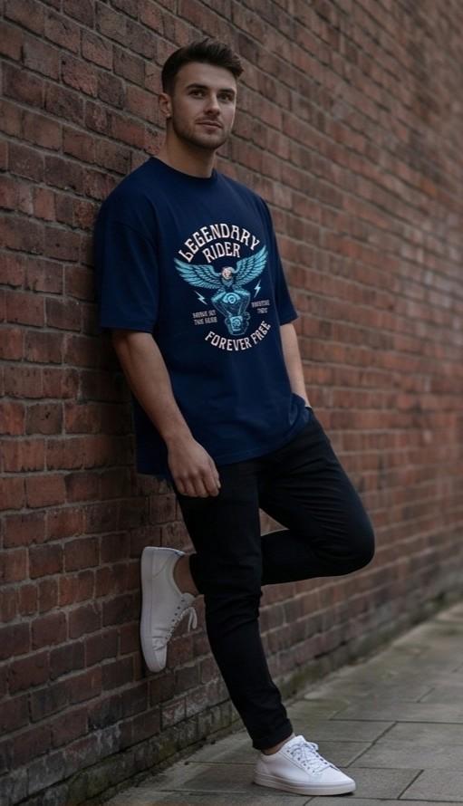 Man in navy graphic tee, black pants, white sneakers