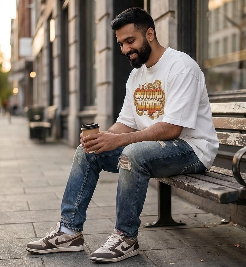 Man in white tee, distressed jeans, and sneakers