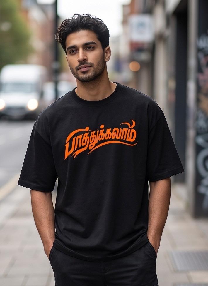 Black oversized t-shirt with orange Tamil text design