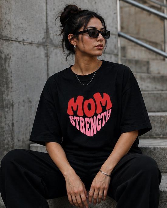 Black oversized t-shirt with red and pink Mom Strength heart graphic
